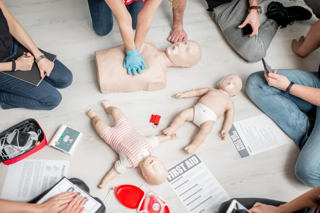 Close-up of CPR chest compressions on adult training manikin