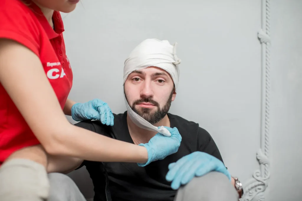 Instructor applying emergency bandage during first aid training session