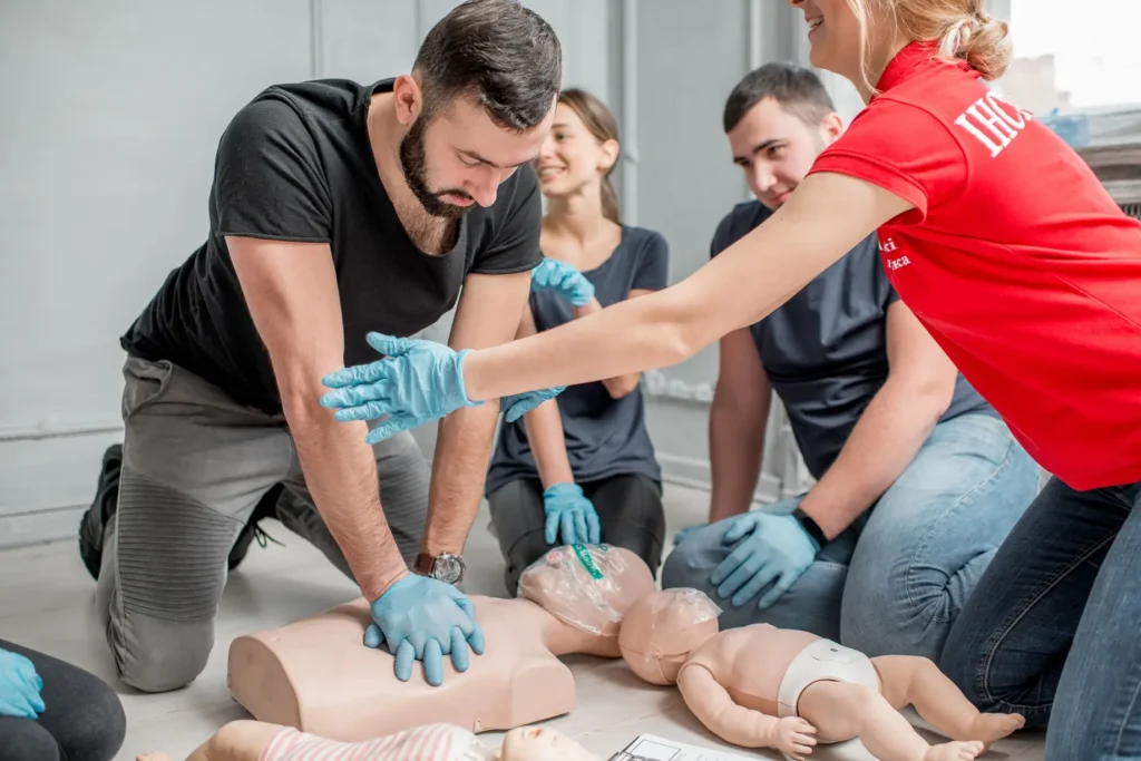 First aid instructor demonstrating emergency response techniques during training course